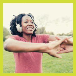 Young woman with earphones on stretching for nature and mental health blog